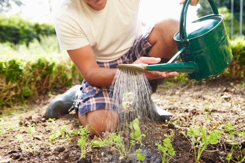 Gardener preparing tools and safety gear before starting work in a Dulwich garden