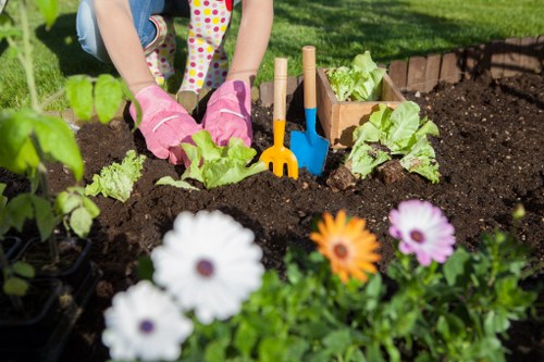 Close-up of gardener pointing at a planting bed with notes